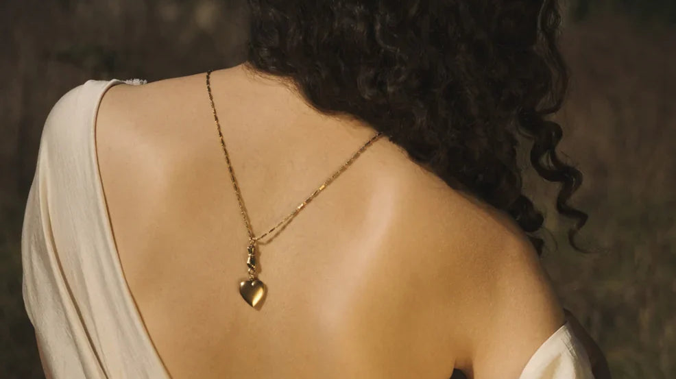 Womans back with a necklace draping down