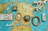 jewlery placed in boxes over an old world map 