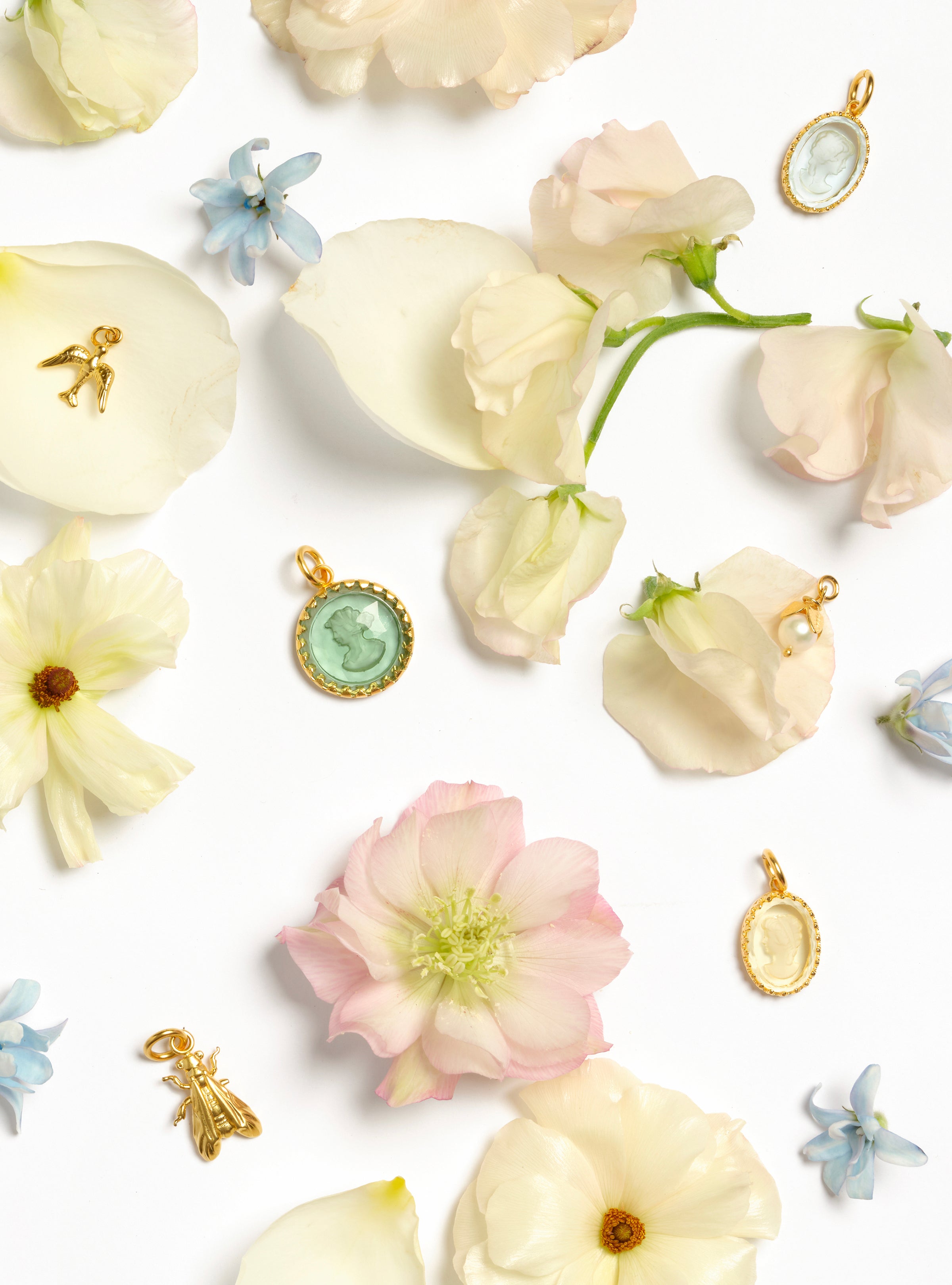 charms sitting on a bed of flowers 